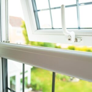 Open white uPVC casement window with lockable handle overlooking a garden